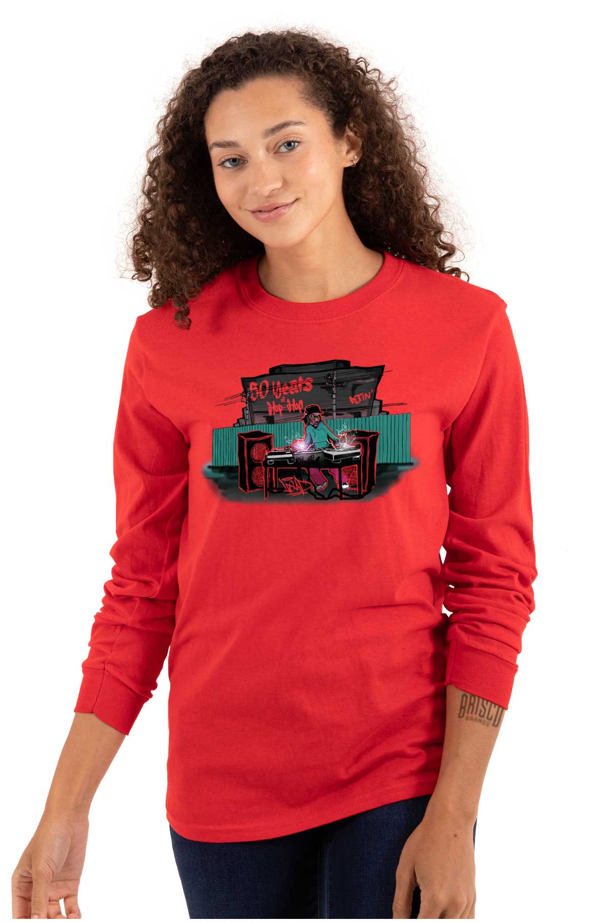 This shirt features a design inspired by urban art with a DJ mixing music and speakers playing. It's a celebration of 50 years of hip-hop and pays homage to its roots.