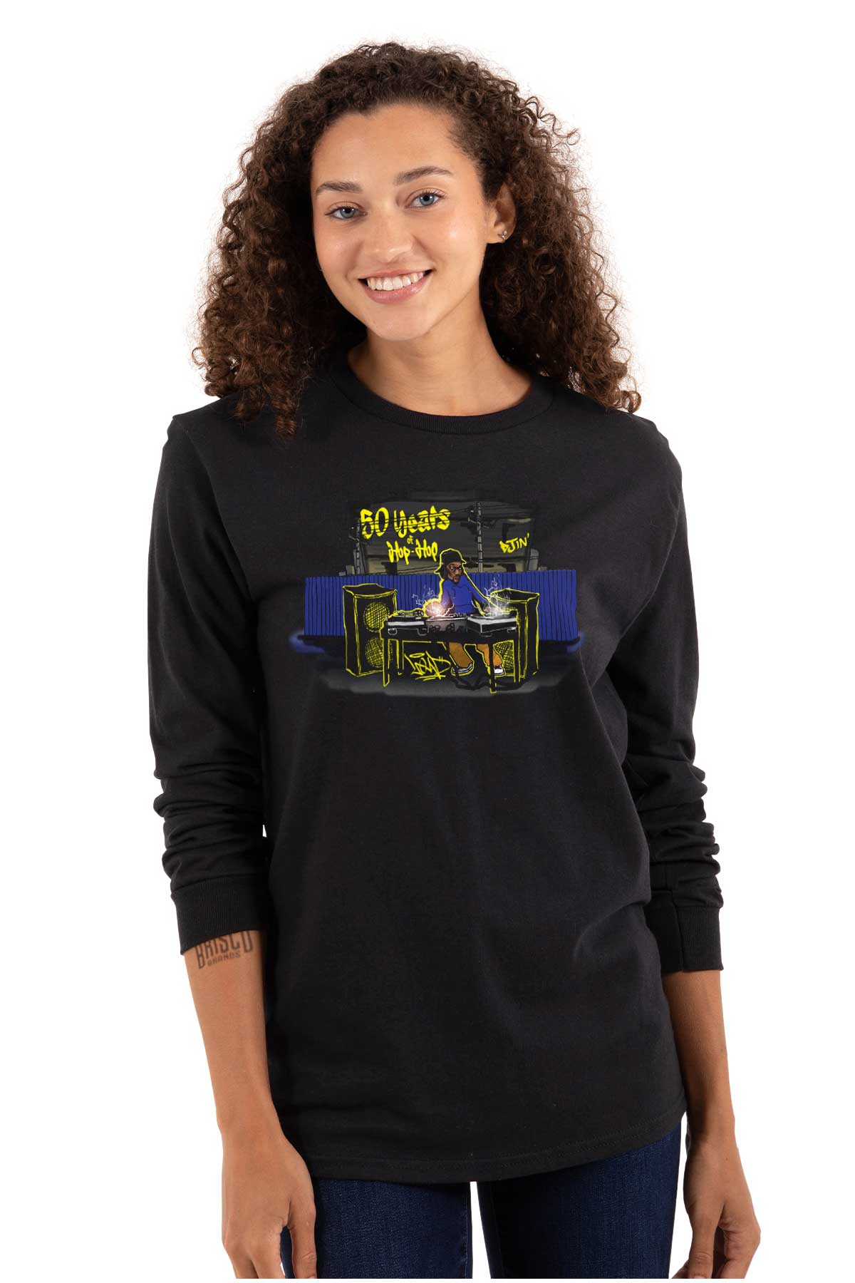 This shirt features a design inspired by urban art with a DJ mixing music and speakers playing. It's a celebration of 50 years of hip-hop and pays homage to its roots.