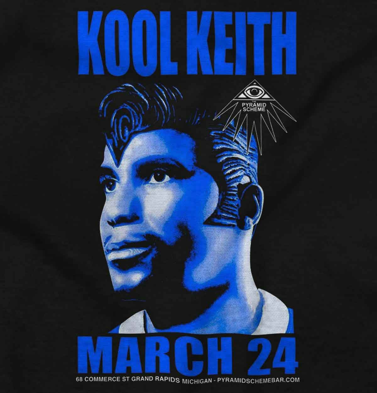 Kool Keith is seen wearing a black Elvis headpiece, symbolizing defiance and originality in fashion, capturing the essence and celebration of Hip Hop's unique style and diverse influences.