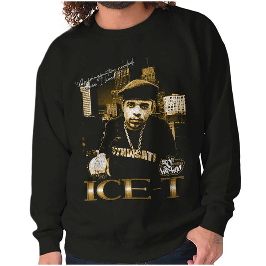 The image shows a confident ICE-T wearing chains in front of city skyscrapers, representing the bold and resilient essence of hip-hop and its legacy.